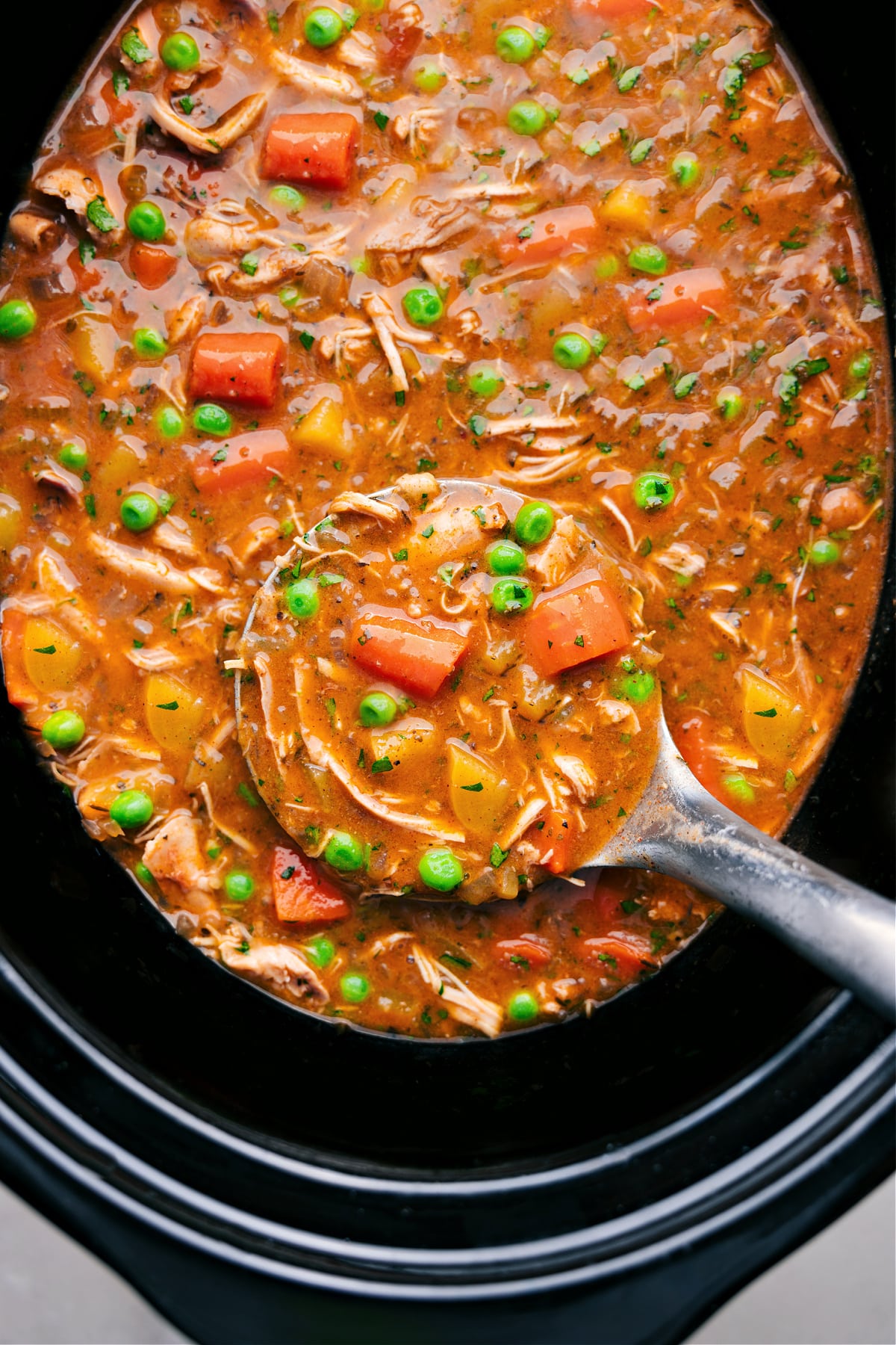 Crockpot Chicken Stew in the crockpot with a big label full coming out.