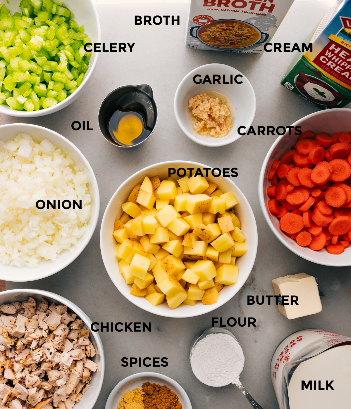 A selection of ingredients laid out for this recipe, including chopped potatoes, onions, carrots, spices, and more, ready to be used in making this recipe.