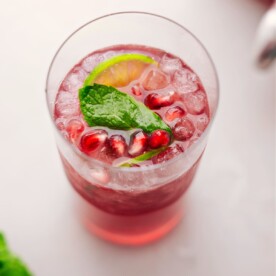 Big glass of Christmas Punch with fresh mint and limes in it.