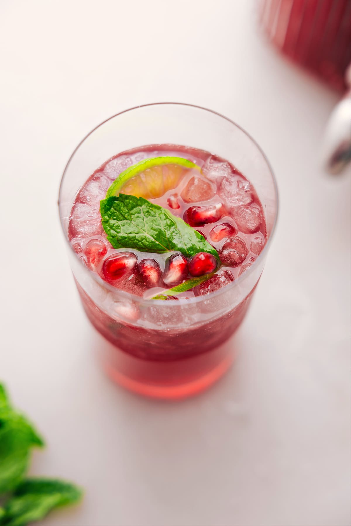 Big glass of Christmas Punch with fresh mint and limes in it.