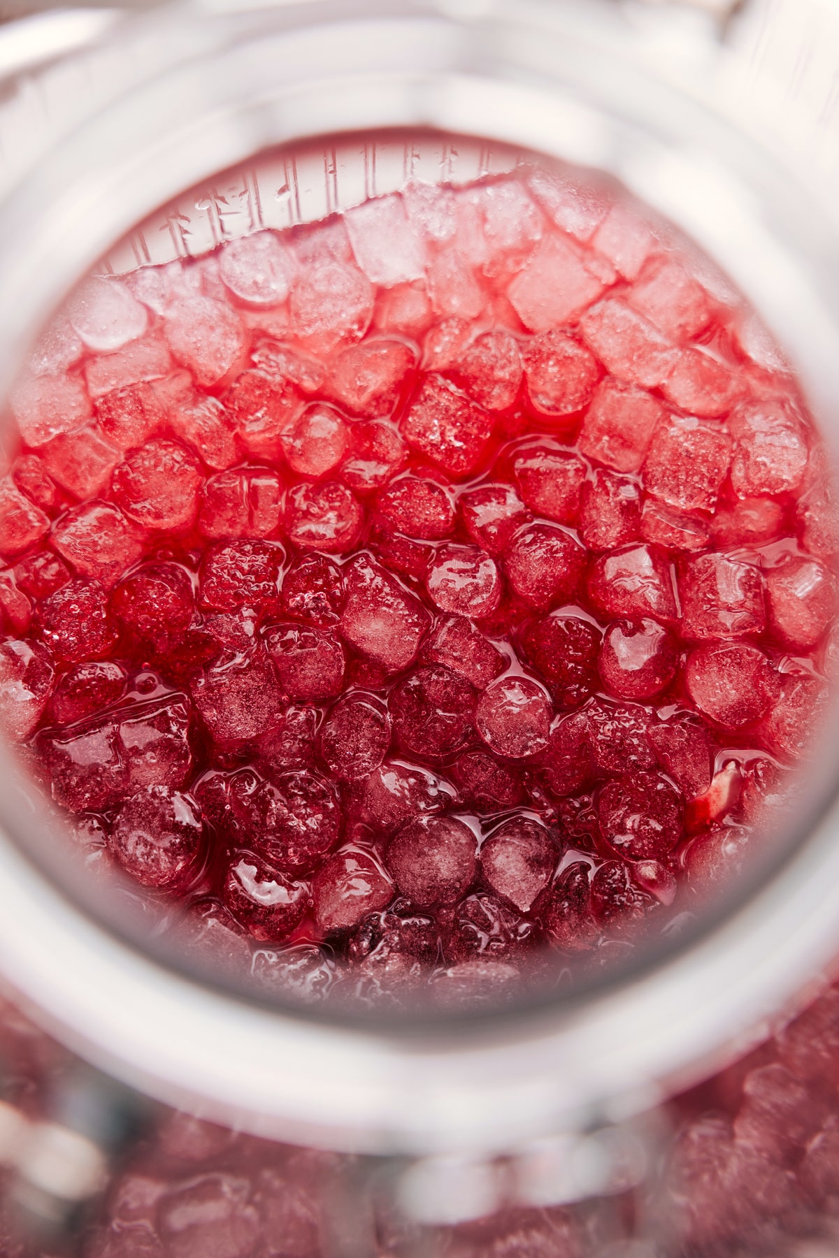 Overhead view of a glass of Christmas Punch served with crushed ice.