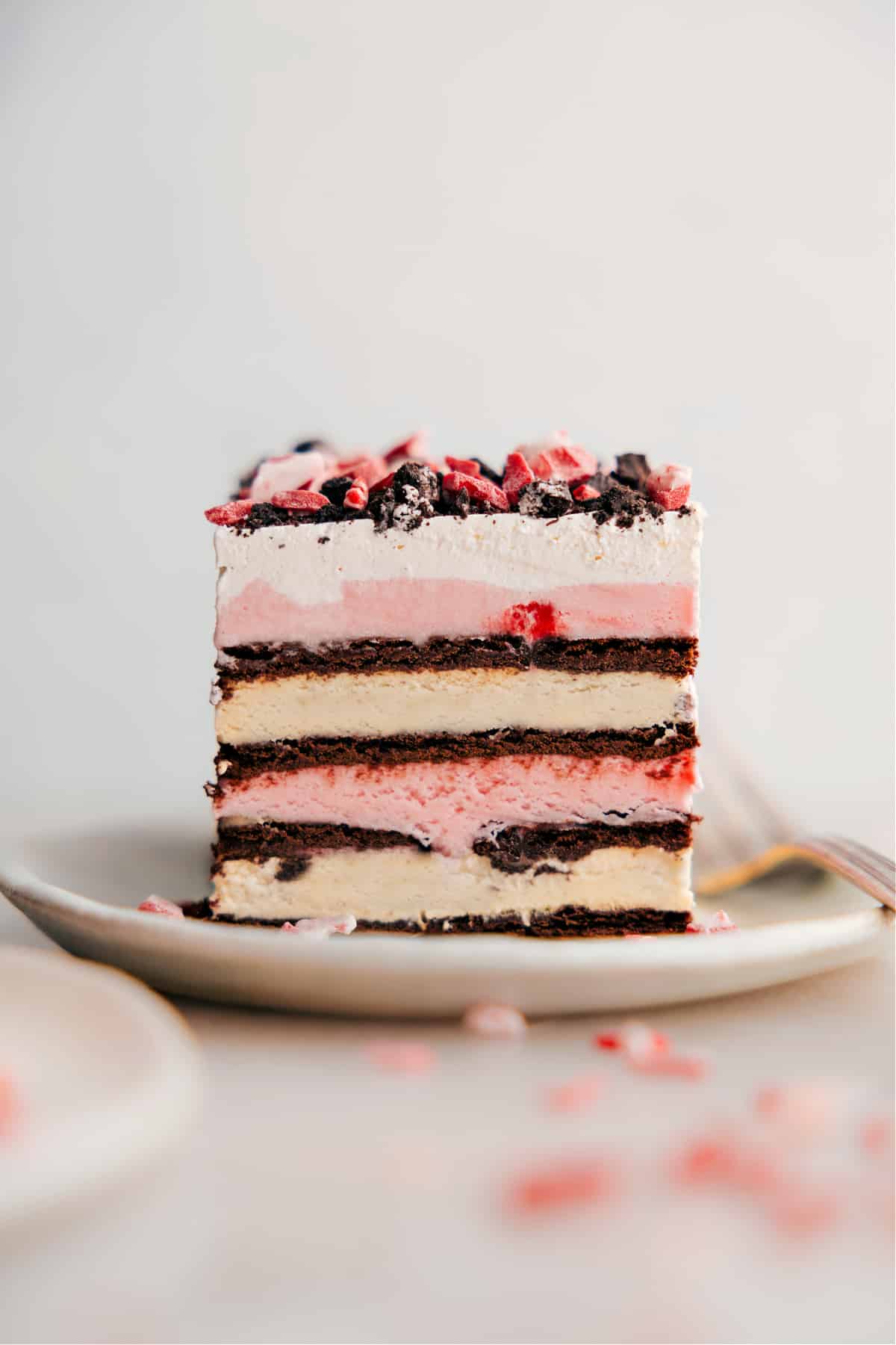 A slice of 3 ingredient peppermint ice cream bars, elegantly plated to showcase its delicious layers, inviting a delightful dessert experience.