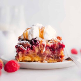 Slice of raspberry bread pudding on a plate ready to be enjoyed.
