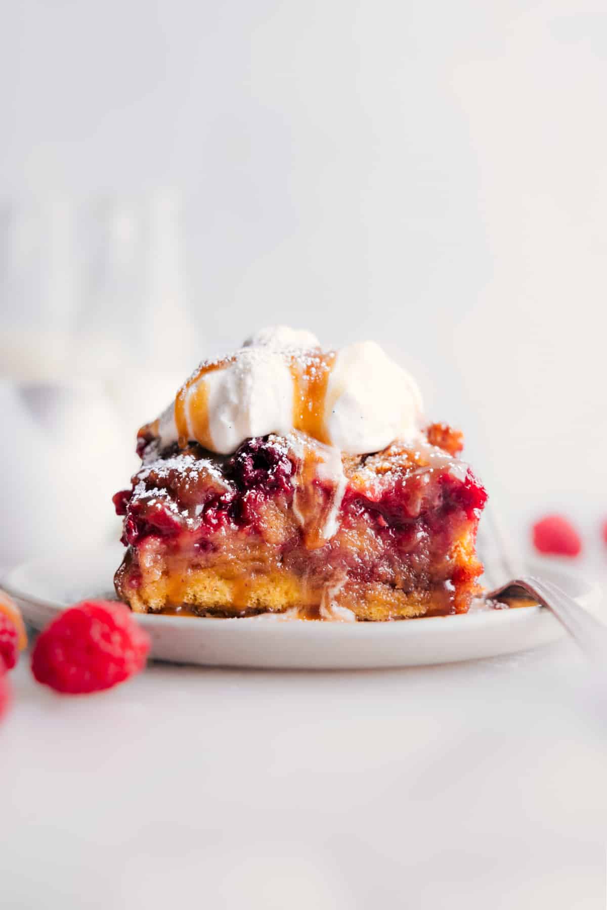 Slice of raspberry bread pudding on a plate ready to be enjoyed.