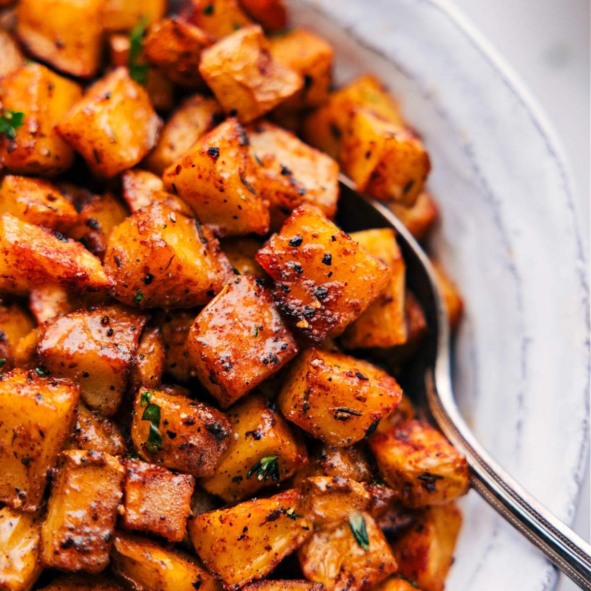 Up-close image of the Breakfast Potatoes with a spoon scooping them out.