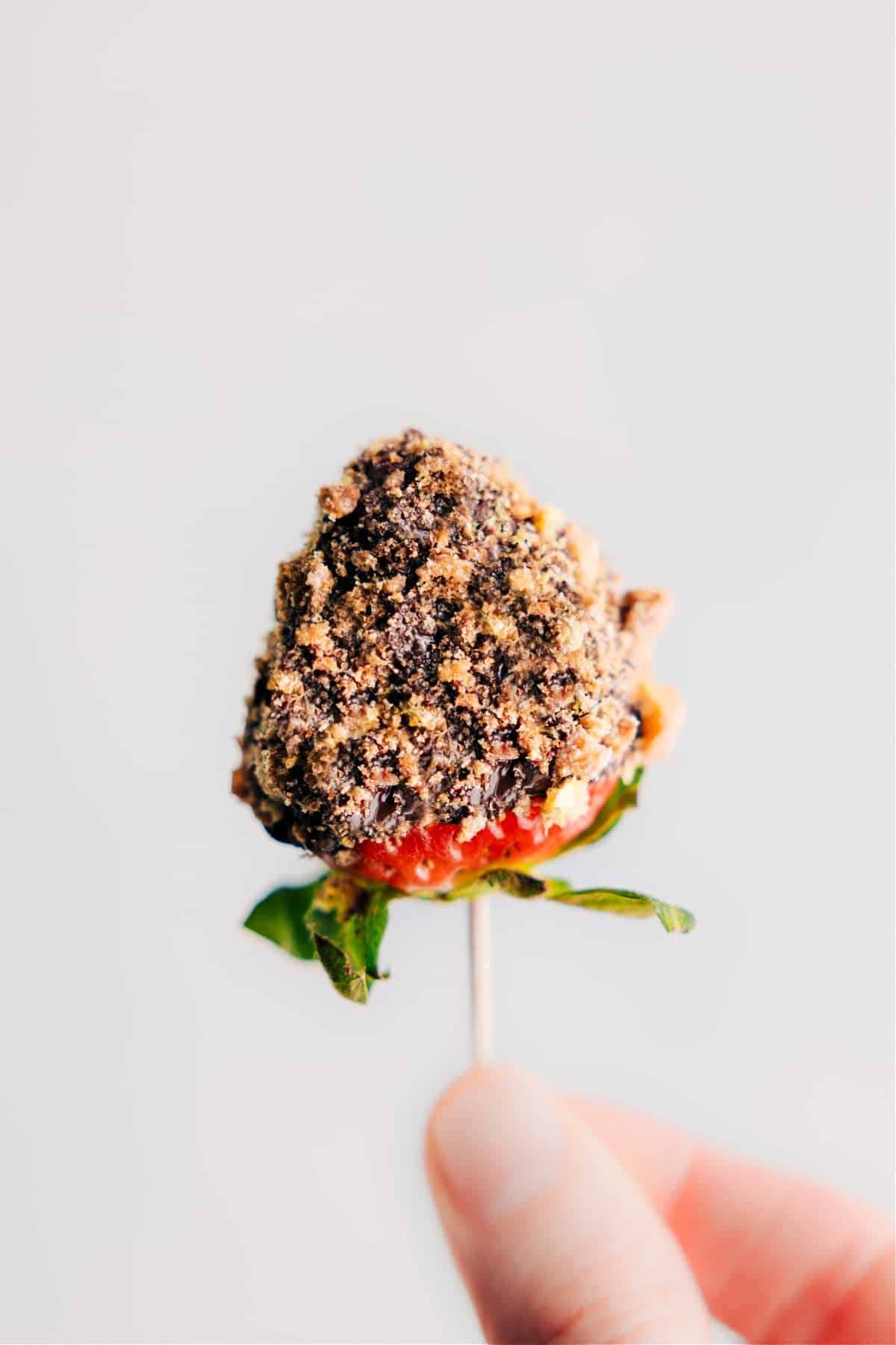 Image of a chocolate-dipped strawberry topped with cookie crumbs