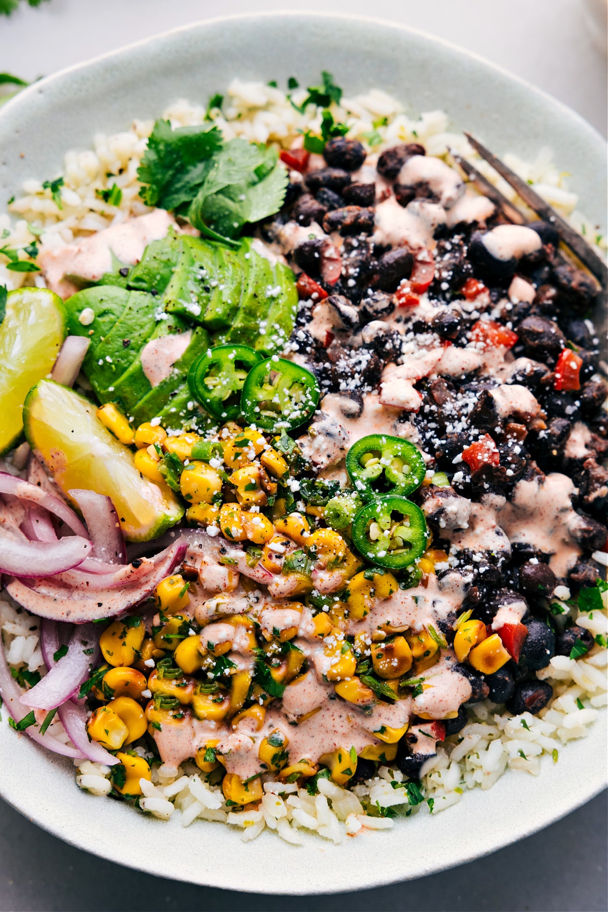 Black Bean Burrito Bowls on a bed of rice ready for to be enjoyed.