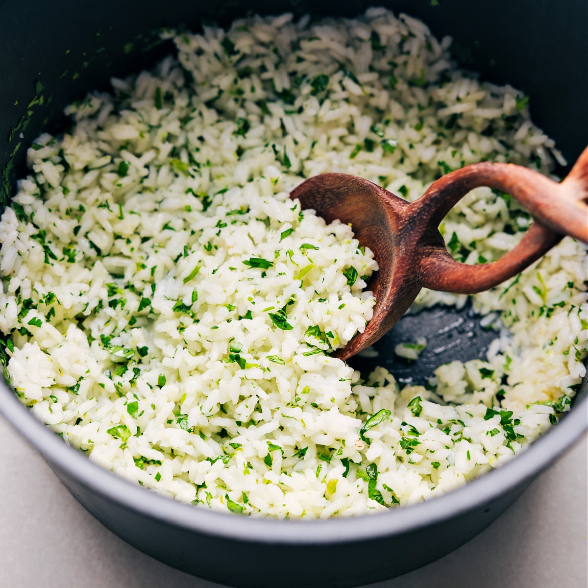 The dish being scooped up by a spoon to serve.