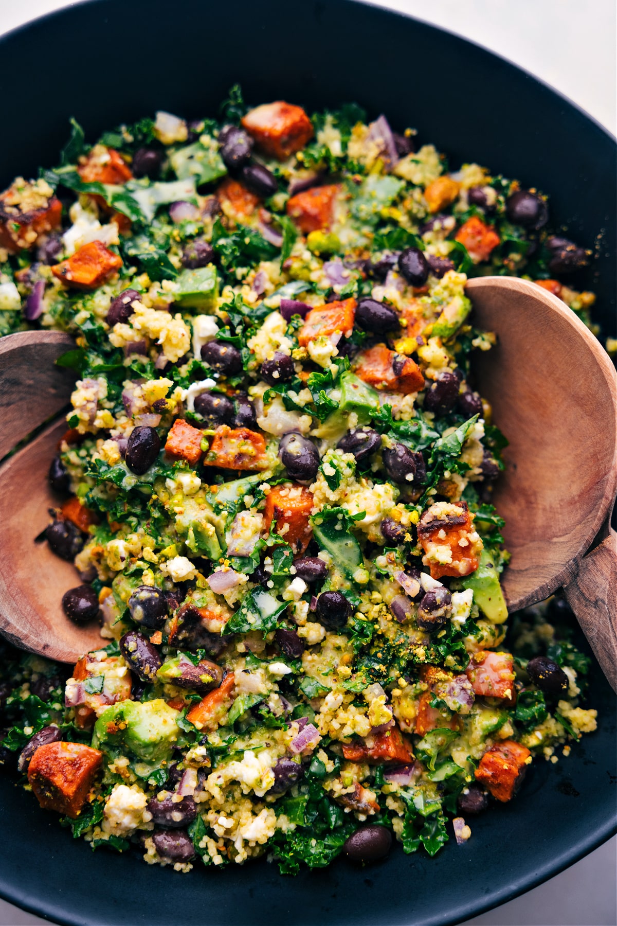 Kale Sweet Potato Salad with spoons in it ready to be enjoyed.