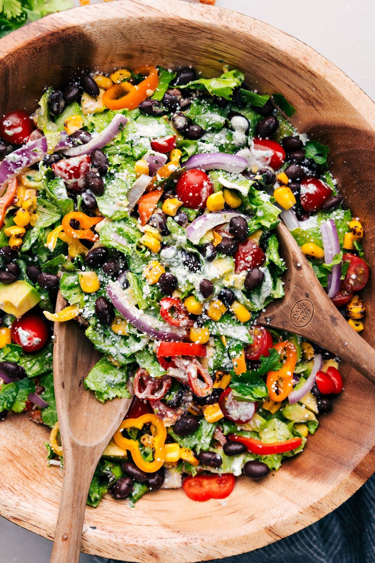 Bowl of Mexican Salad with serving utensils.