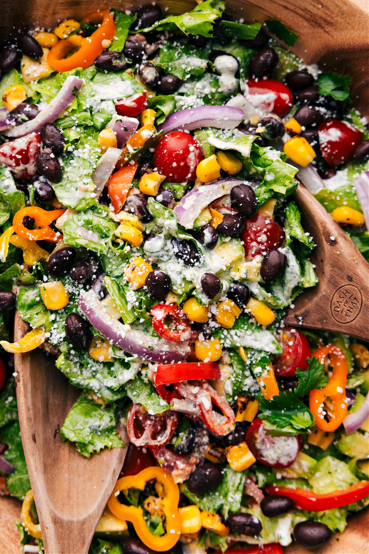 Mexican Salad being tossed with the dressing.