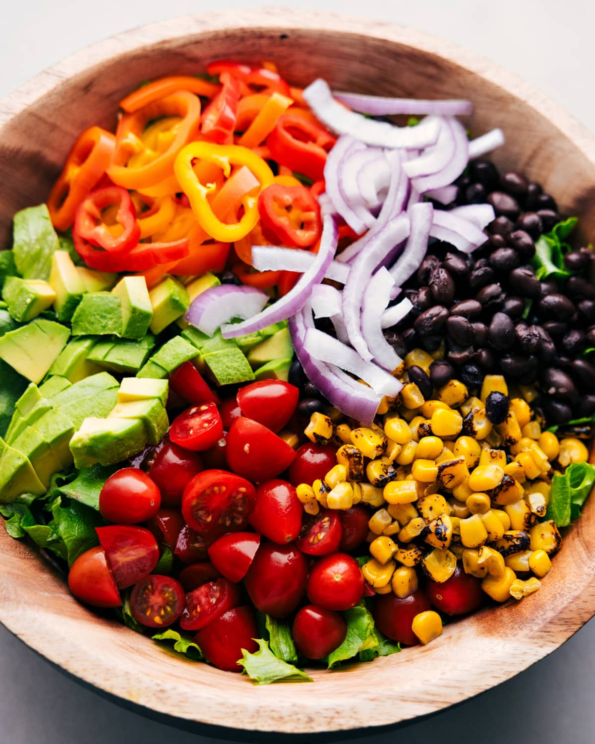 All of the salad ingredients in a bowl.