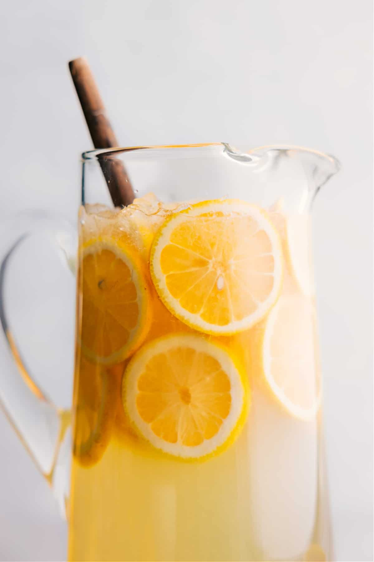 Lemonade in a pitcher ready to be served, garnished with fresh lemons.