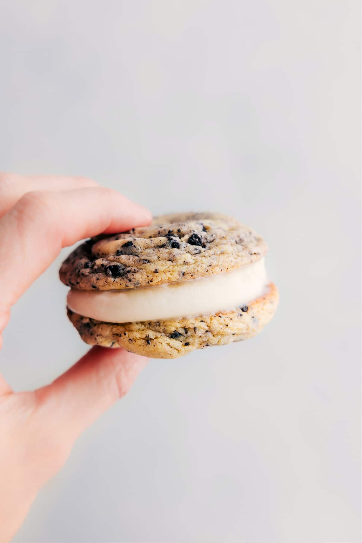 One of the oreo whoopie pies being held up showing the yummy layers.