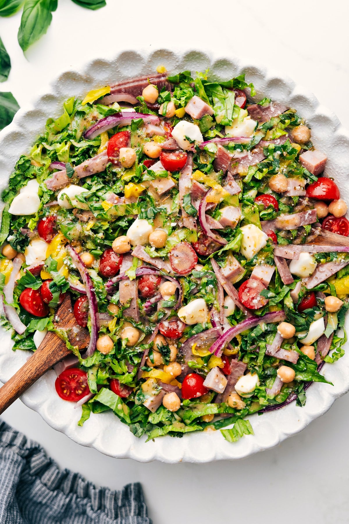 Italian Chopped Salad Fresh chopped salad loaded with salami, ham, chickpeas, mozzarella, pepperoncini, basil, and lemon dressing.
