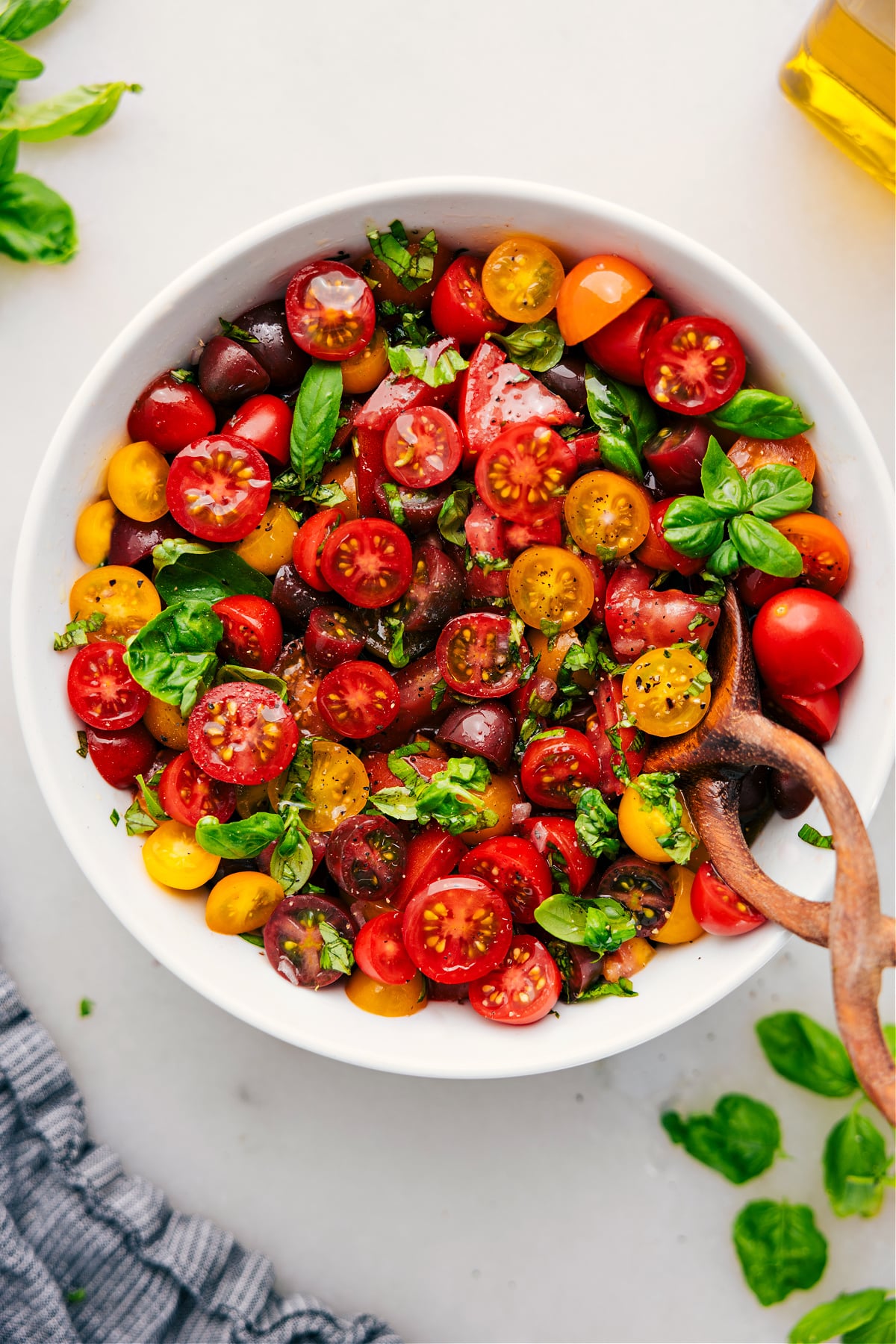 The Best Tomato Salad Recipe Tomato Salad in a bowl with fresh basil.