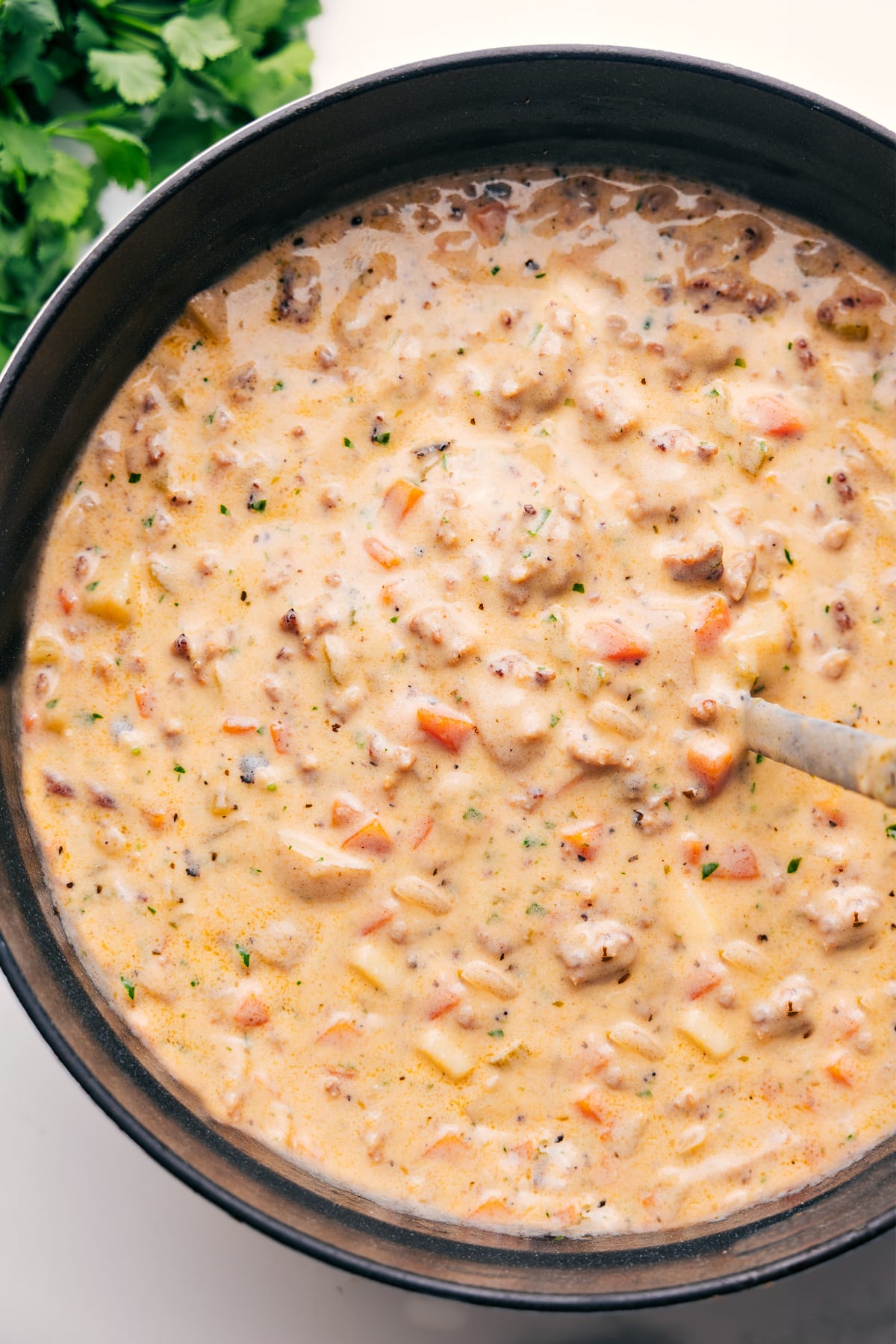 The Best Sausage Potato Soup Recipe Sausage potato soup in a pot, ready to serve.