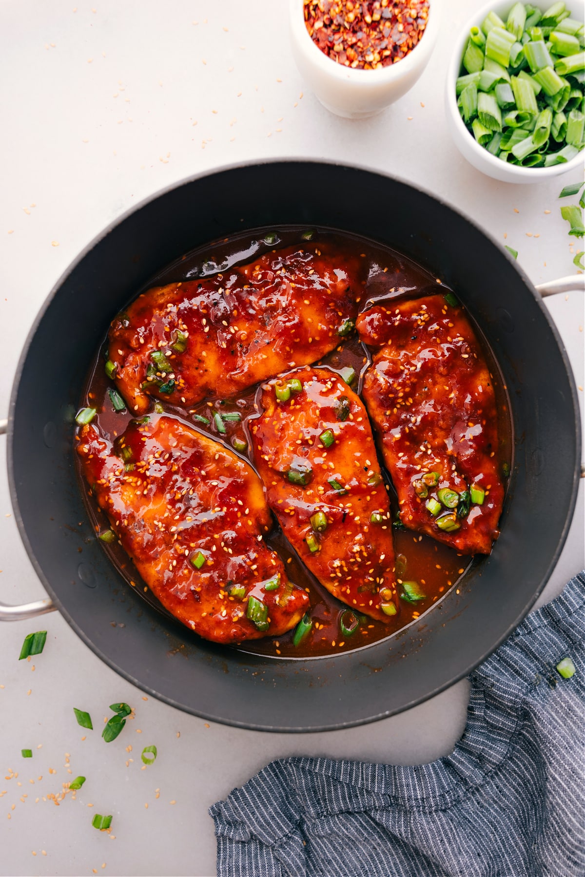 The Best And Easiest Honey Garlic Chicken Honey Garlic Chicken cooks in a skillet and gets a topping of green onions.