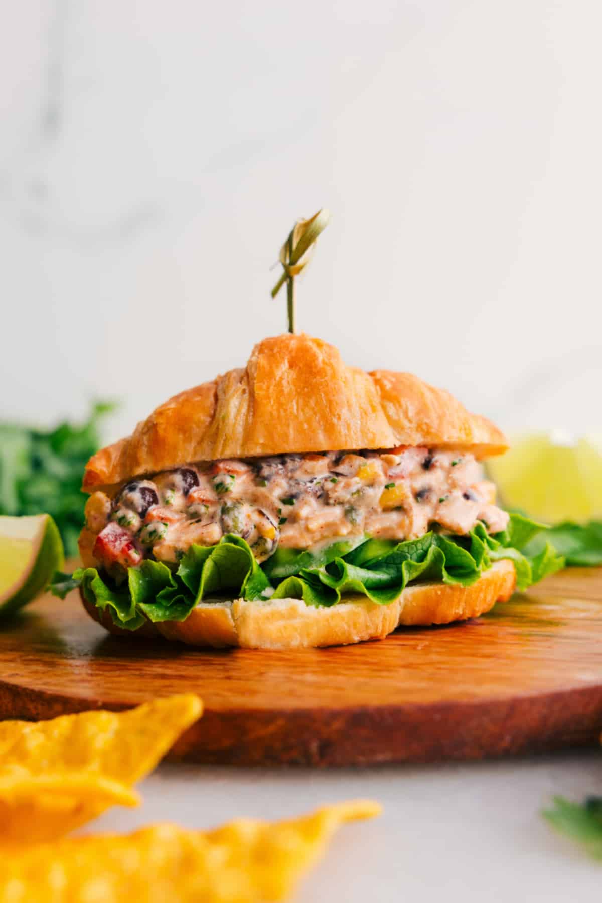 The Best Southwest Chicken Salad Recipe Southwest Chicken Salad on a croissant with lettuce.