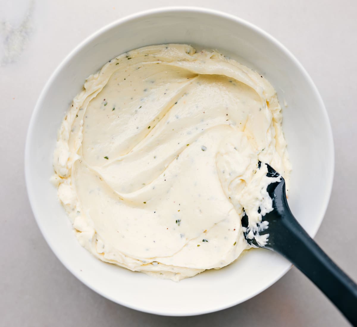 The spread is mixed in a bowl, ready to be added to the avocado sandwich.
