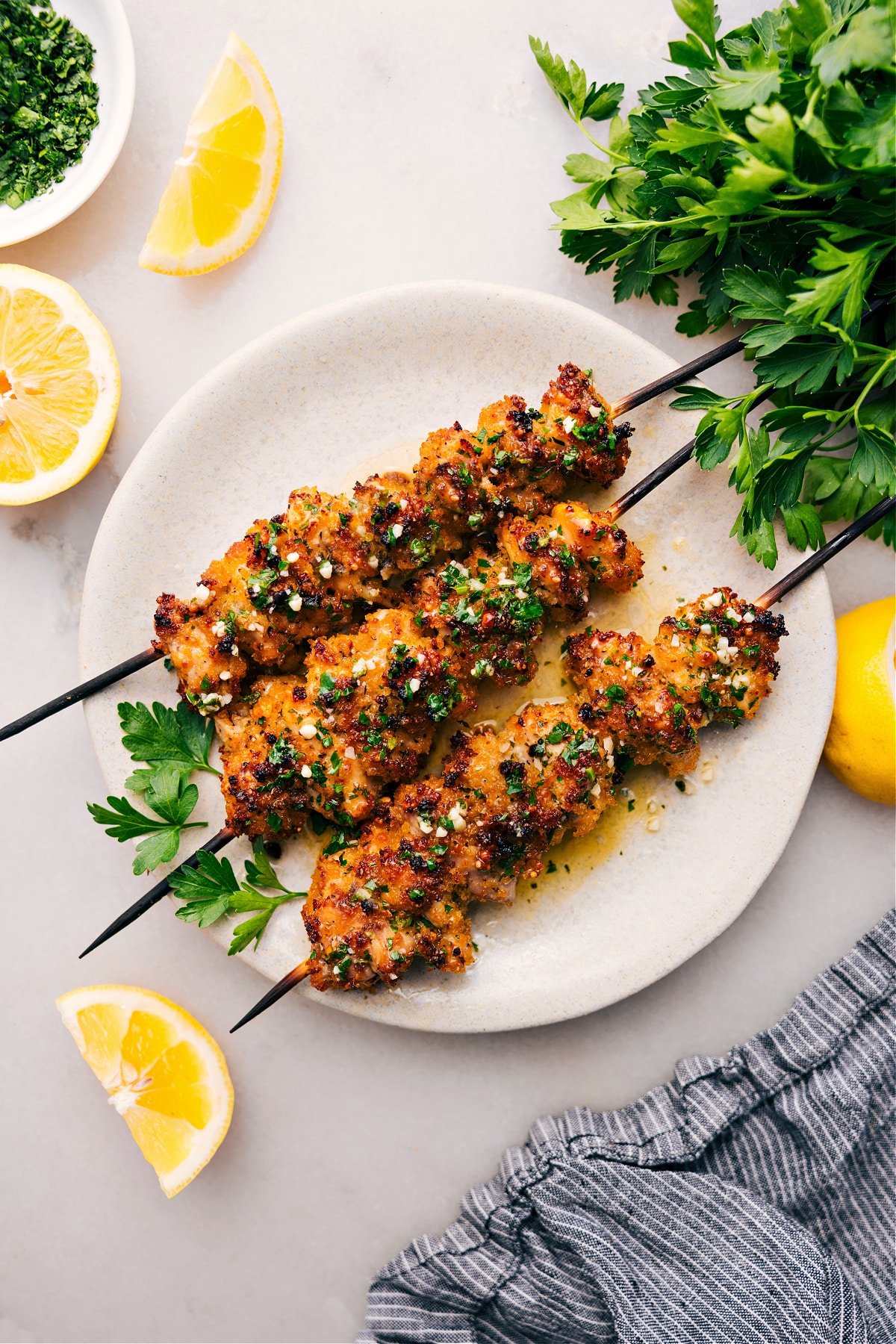 Chicken Spiedini sit on skewers, plated and ready to enjoy.









