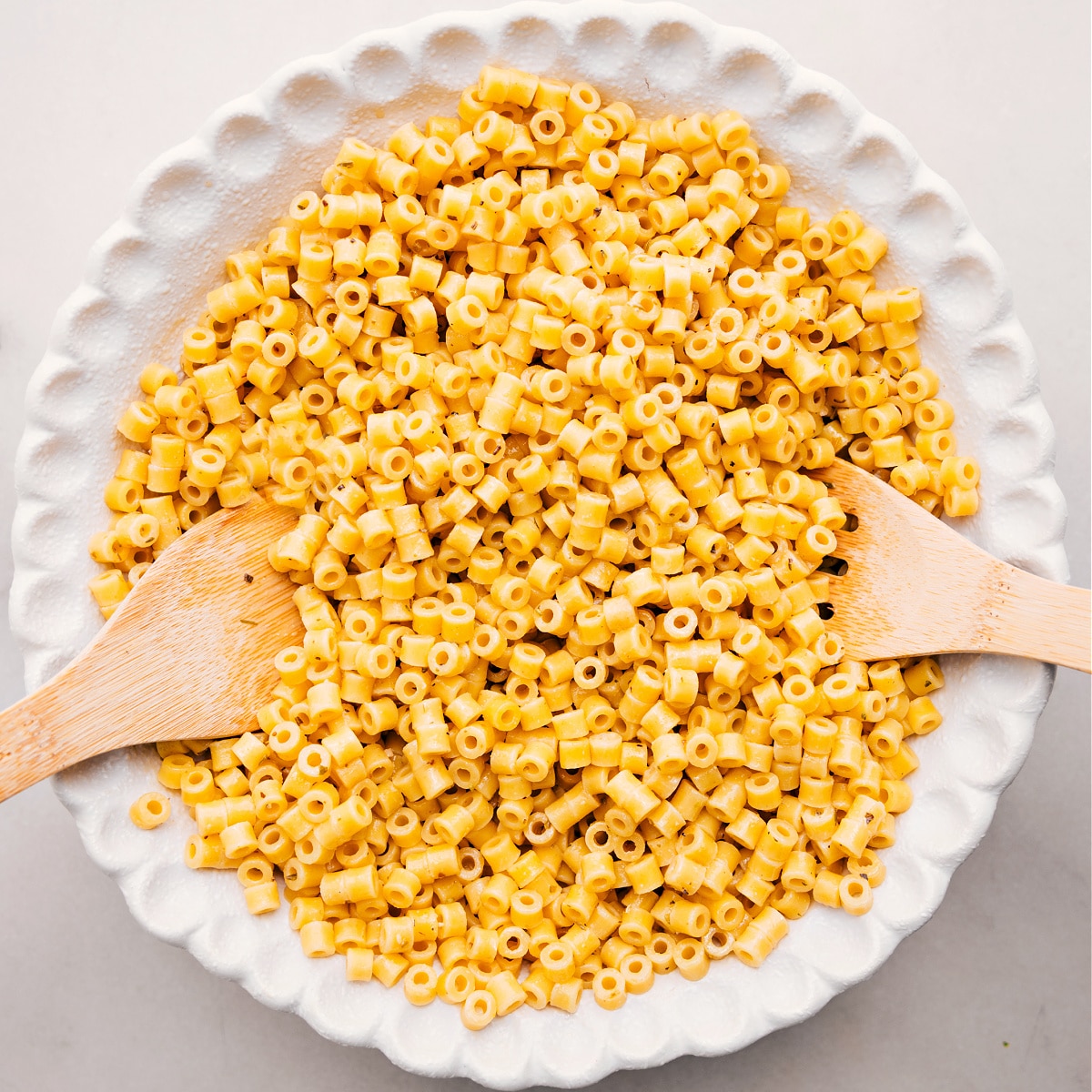 Cooked pasta sits in a bowl, ready to toss with the other ingredients for this Italian Grinder Pasta Salad.