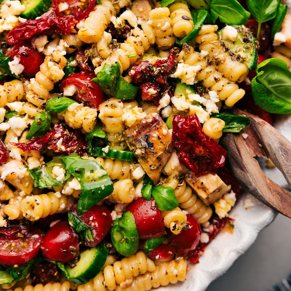 Marry me chicken pasta salad recipe in a bowl tossed with the dressing.
