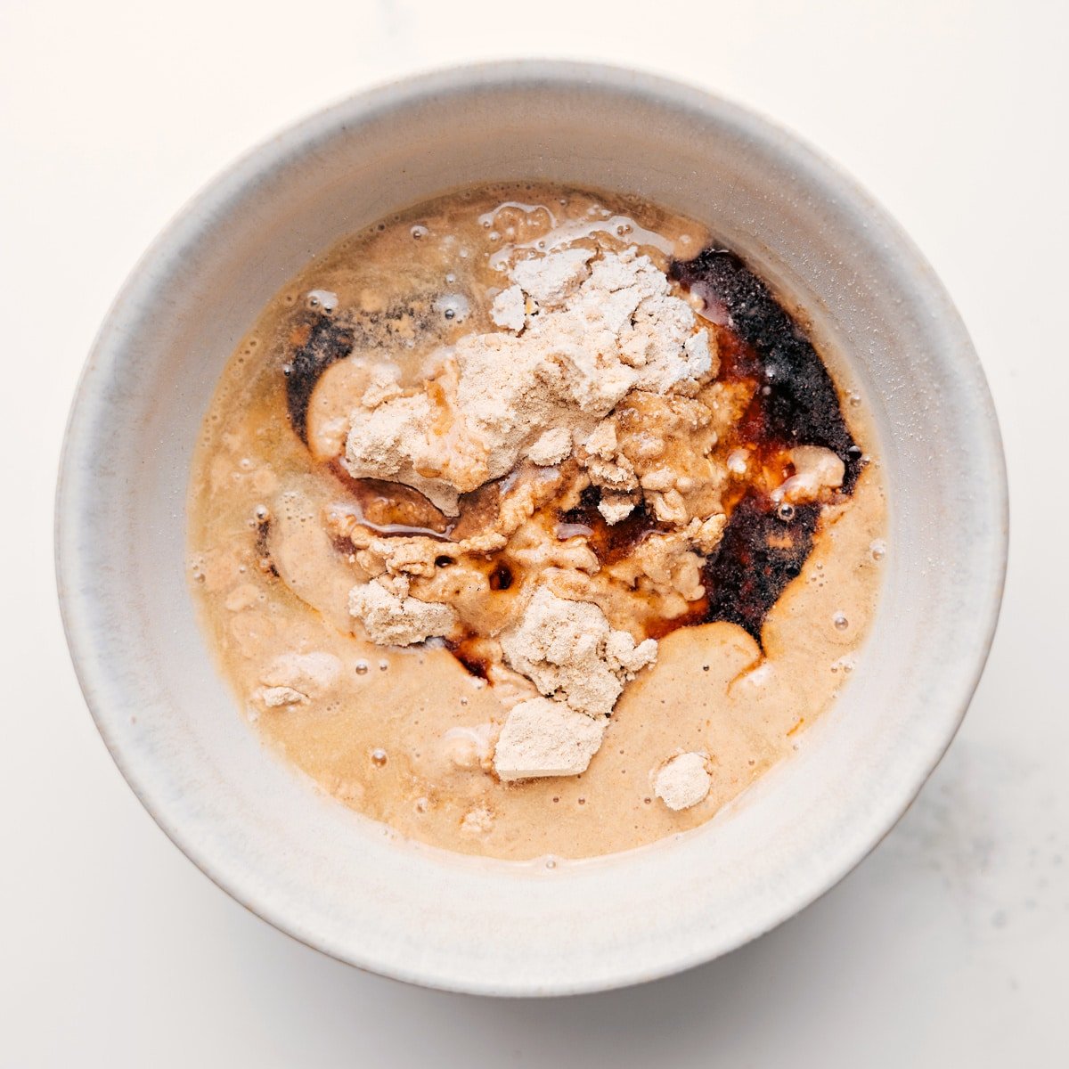 All the ingredients for protein cookie dough combined in a bowl to create the most delicious high-protein treat.
