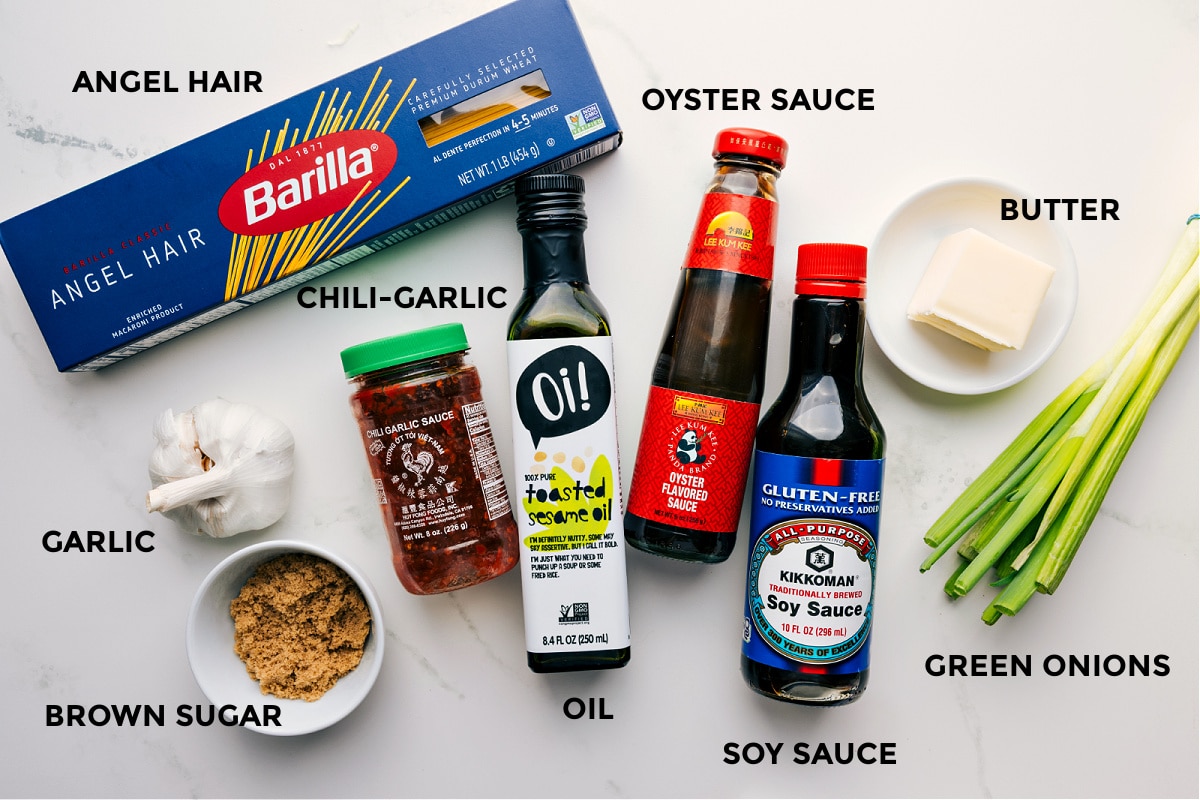 All the ingredients for Chili Garlic Noodles prepped and ready, including angel hair pasta, oyster sauce, butter, green onions, soy sauce, oil, chili garlic sauce, garlic, and brown sugar.