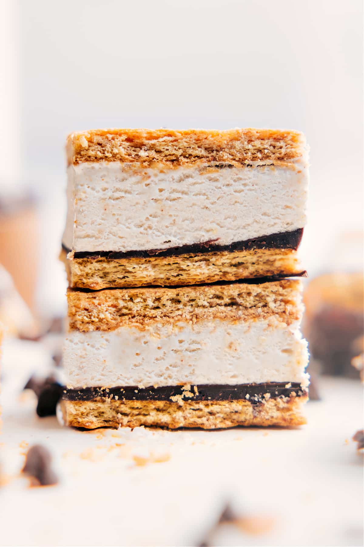 The Ultimate Summer Treat: Frozen Protein S'mores Frozen Protein S’mores stacked in a neat pile, showing the creamy center and chocolate layers, ready to be enjoyed.