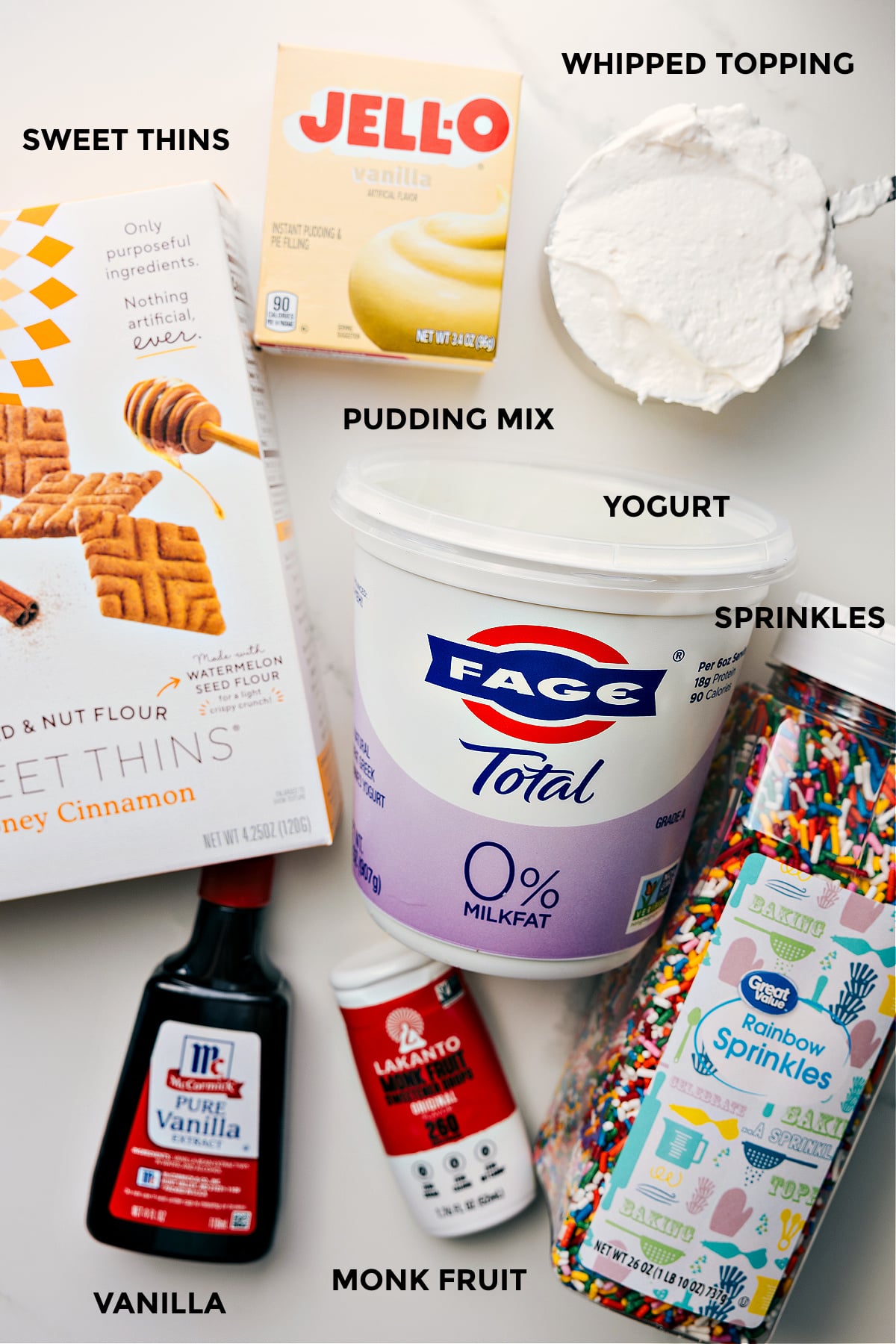 All the ingredients prepped for easy assembly, including graham crackers for dipping, yogurt, sprinkles, monk fruit sweetener, and vanilla.