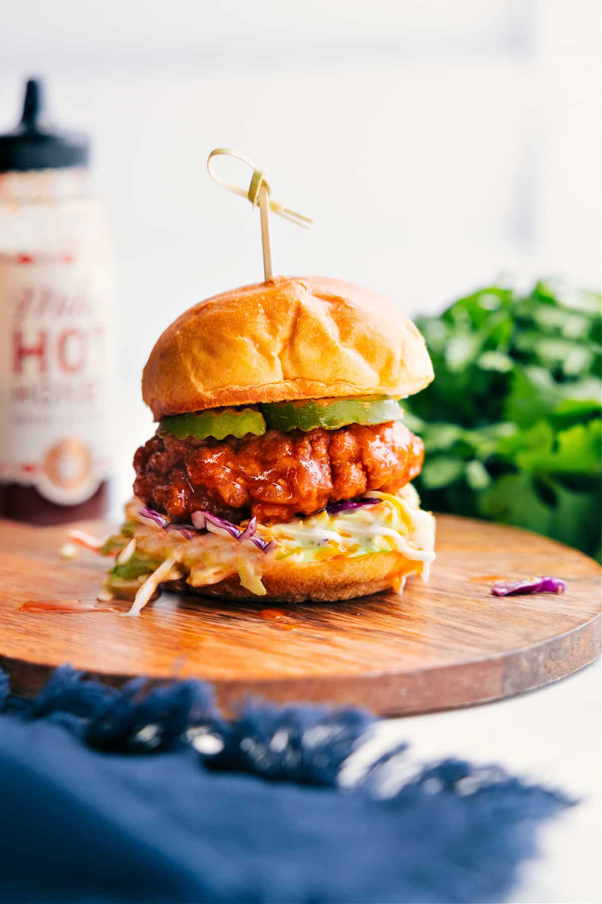 15-Minute Hot Honey Chicken Sliders Recipe Hot Honey Chicken Sliders layered with coleslaw and pickles on soft slider buns.