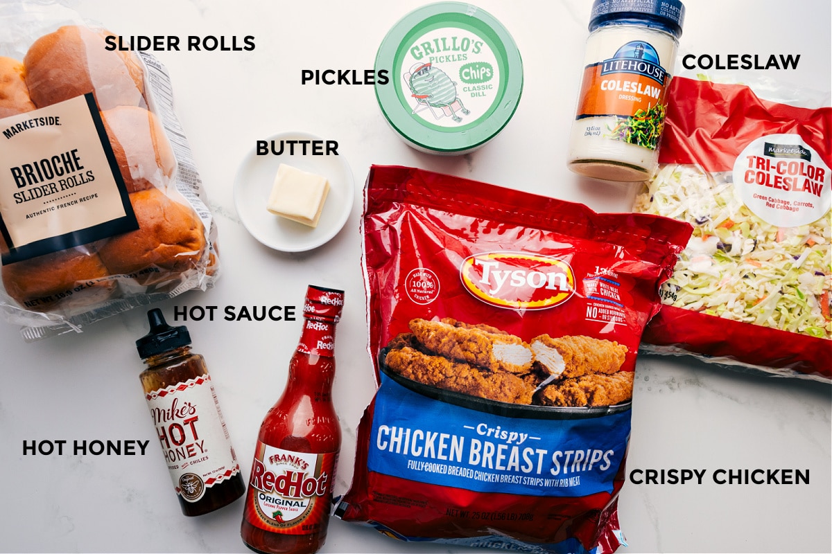 Ingredients prepped for Hot Honey Chicken Sliders: rolls, honey, hot sauce, butter, pickles, coleslaw, crispy chicken, and dressing.
