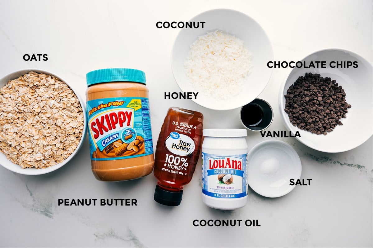 Prepped ingredients for Peanut Butter Granola including oats, peanut butter, coconut, honey, coconut oil, vanilla, salt, and chocolate chips.