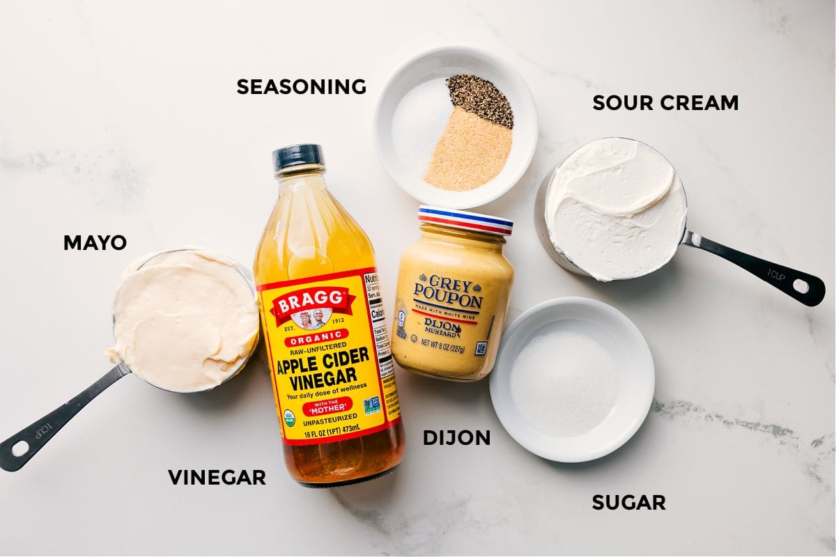 The dressing ingredients in this chicken macaroni salad prepped out for easy assembly including the mayo, vinegar, seasoning, sour cream, dijon, and sugar.