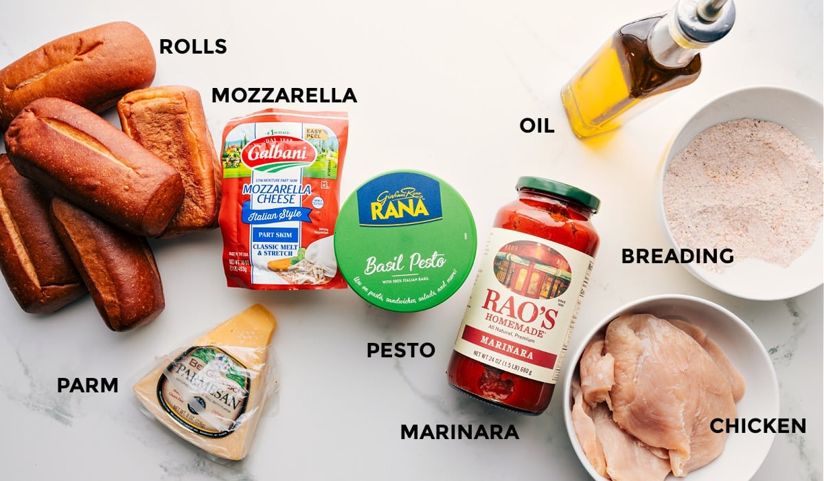 All the ingredients prepped and ready for easy assembly: rolls, mozzarella, parmesan, pesto, marinara, breading, oil, and chicken.