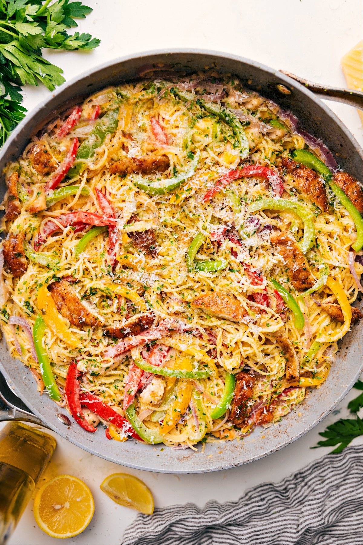 One Skillet Chicken Scampi Recipe Chicken Scampi in a skillet topped with freshly grated cheese, ready to serve.