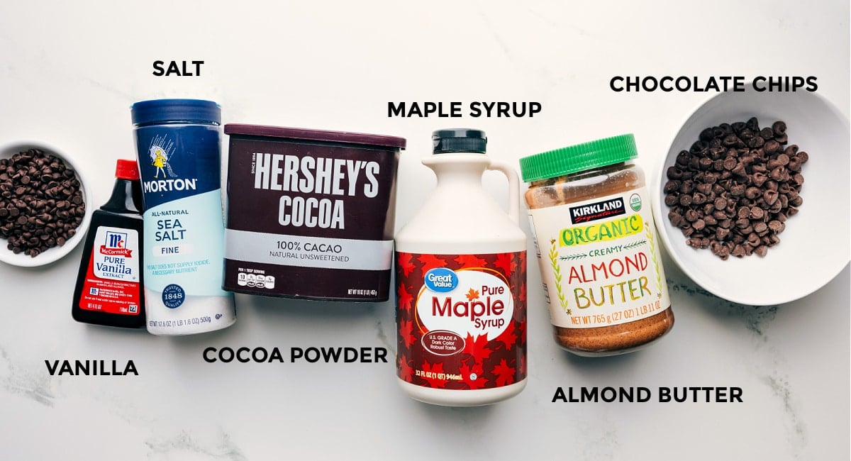 Ingredients in this recipe prepped out for easy assembly including the chocolate chips, vanilla, cocoa powder, maple syrup, and almond butter.