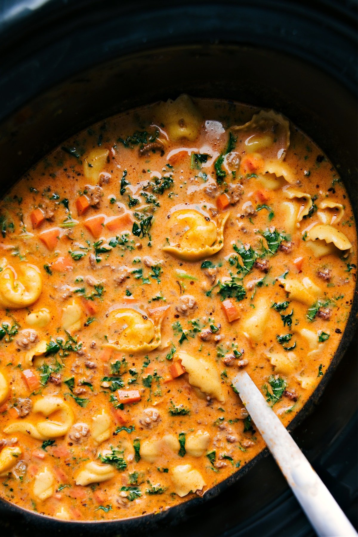 Simple And Delicious Crockpot Tortellini Soup Recipe Crockpot Tortellini Soup in the slow cooker, hot and ready to serve.
