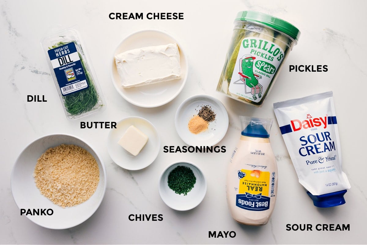 All ingredients prepped for easy assembly: dill, cream cheese, panko, butter, seasonings, chives, mayo, sour cream, and pickles.