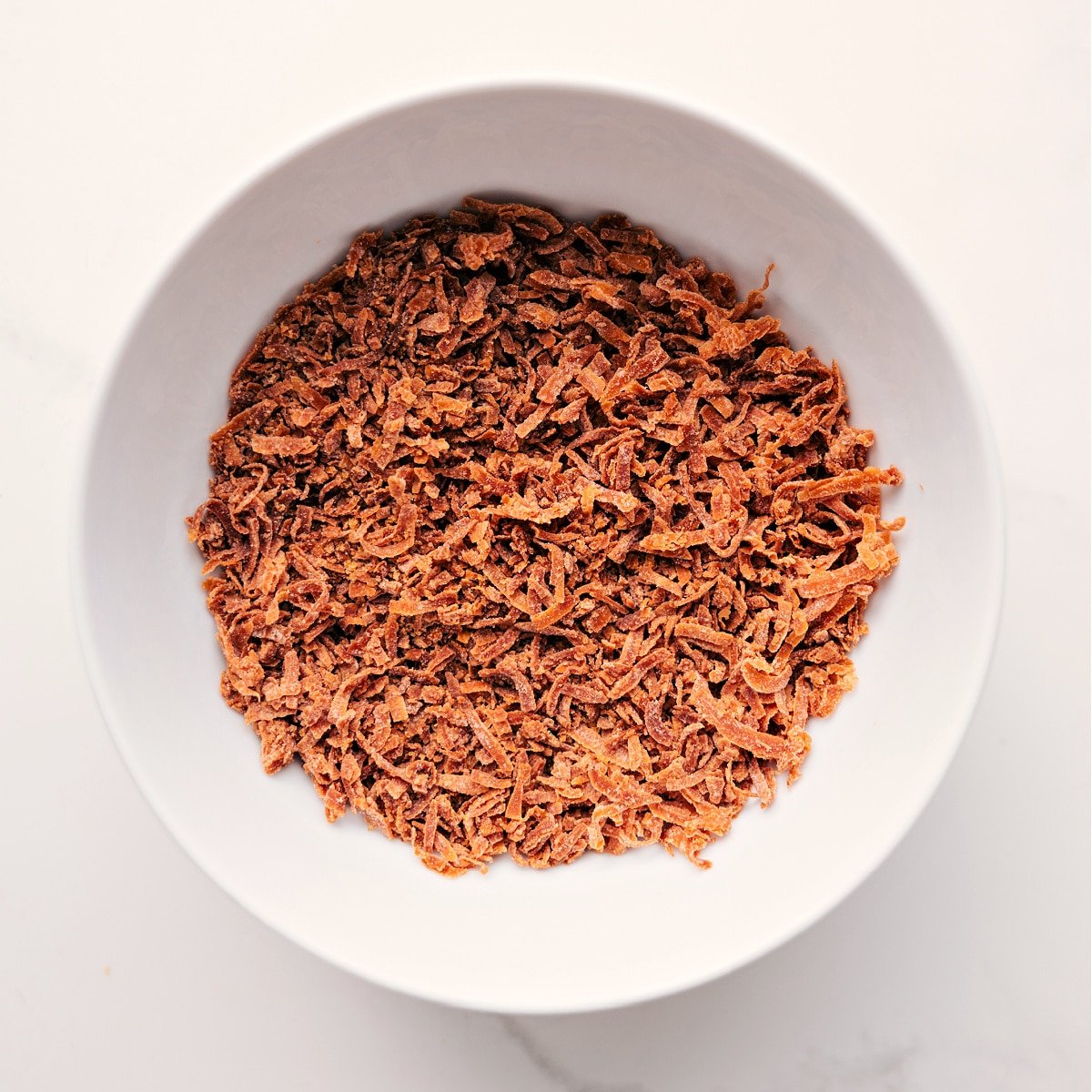 Toasted coconut prepared to sprinkle on top of this dessert.