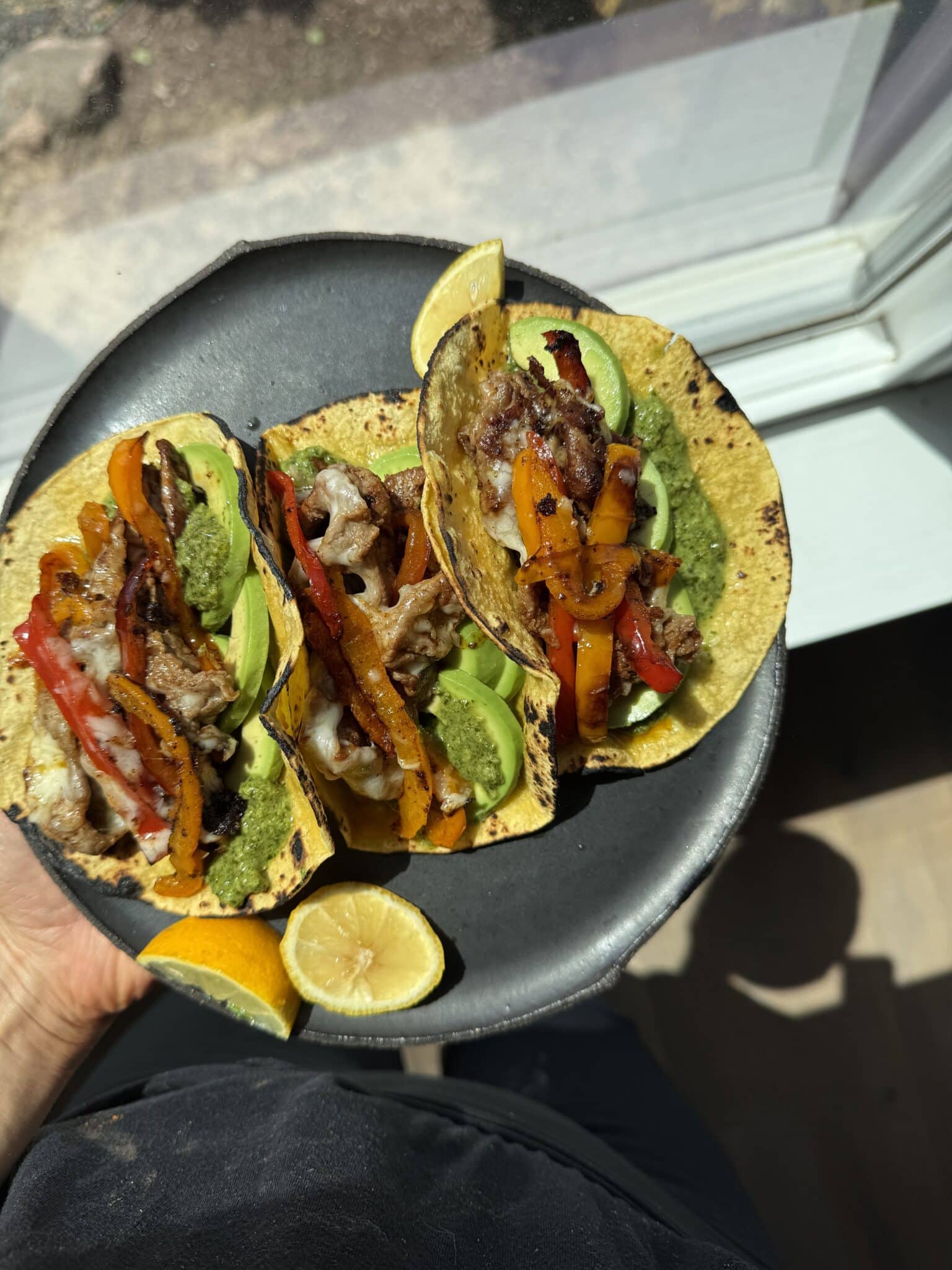 Shaved beef tacos on a plate ready to be enjoyed.
