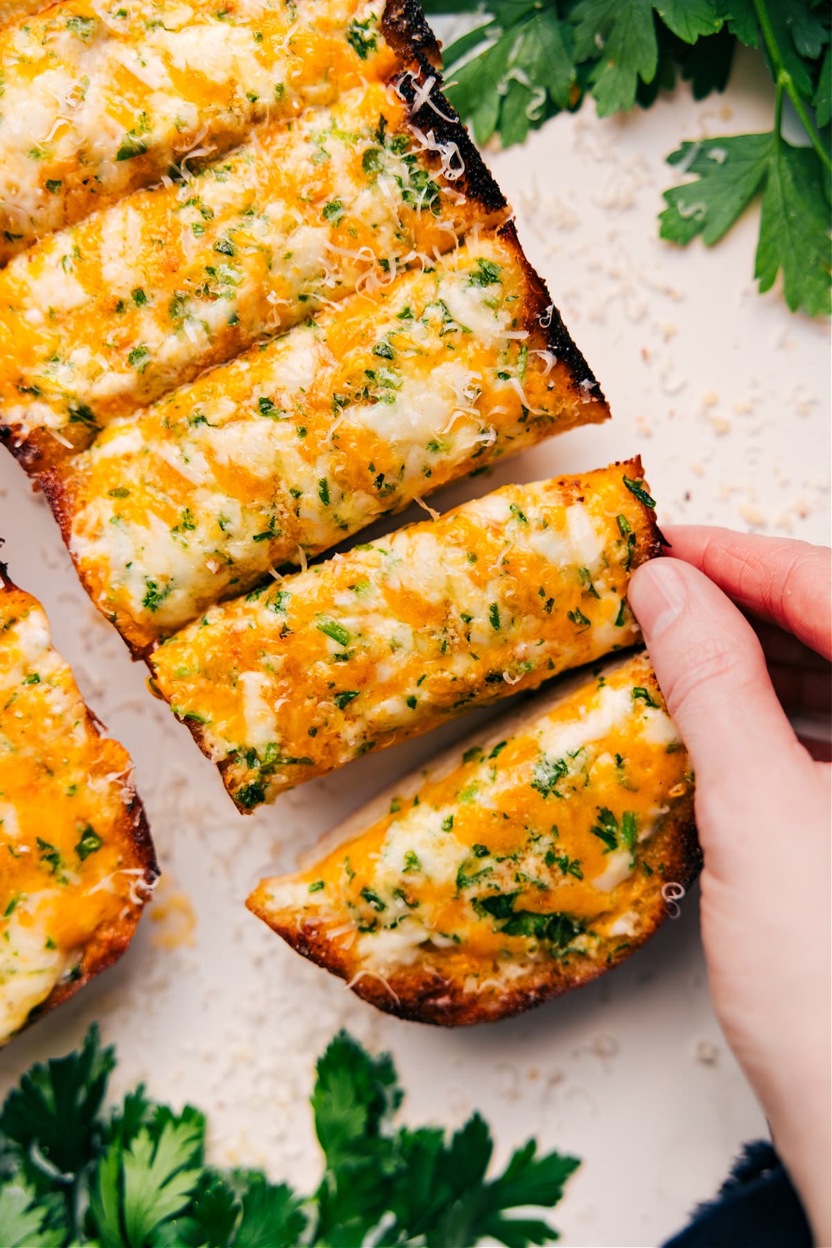 Cheesy Bread Recipe sliced into thick pieces on a board, ready to be served and enjoyed.