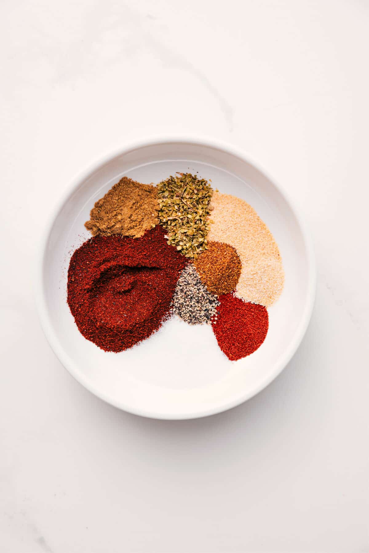 Simple And Delicious Chili Seasoning Recipe Chili Seasoning Recipe in a bowl all prepped out to mix together.