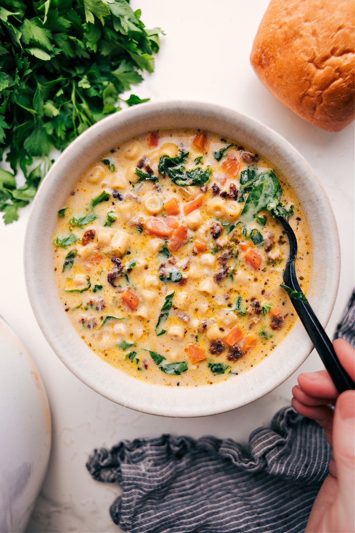 The Ultimate Comfort Food: Creamy Parmesan Italian Sausage Soup The soup in a bowl ready to be enjoyed with some crusty bread on the side.