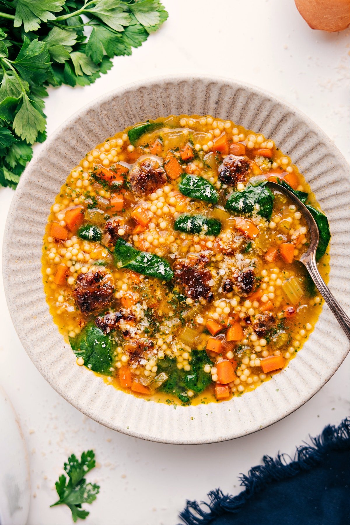 Italian Wedding Soup Recipe served in a bowl with a spoon.