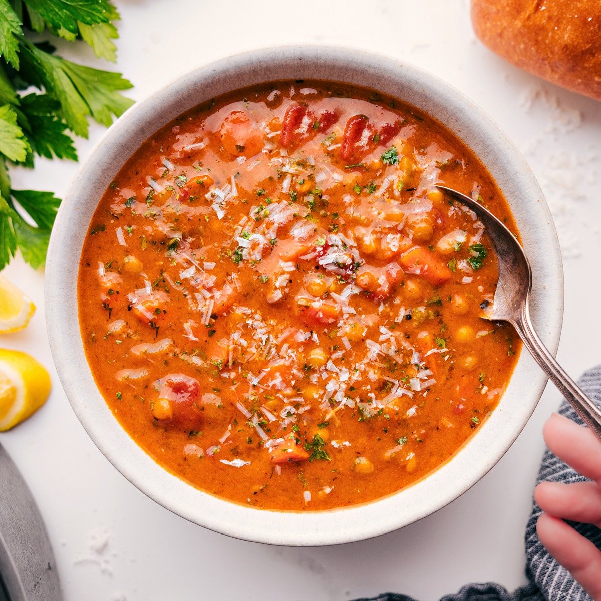 A bowl full of the flavorful and delicious soup with fresh parmesan grated on top.
