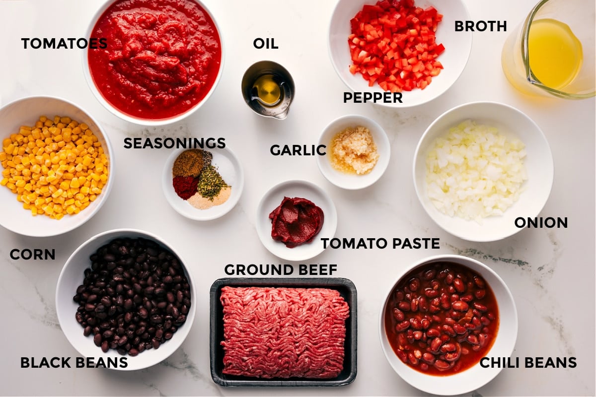 Ingredients In Cornbread Casserole Recipe The ingredients in this recipe prepped out for easy assembly including the corn, black beans, tomatoes, seasonings, oil, ground beef, garlic, peppers, onions, chili beans, and broth.