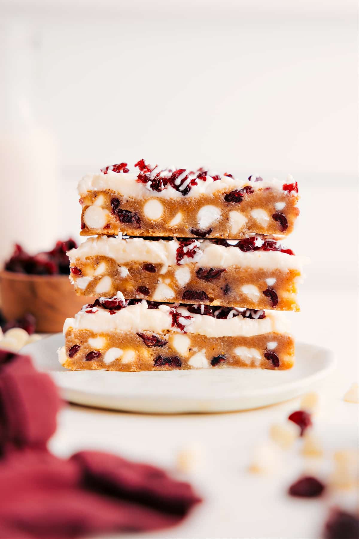 Starbucks Copycat Cranberry Bliss Bars Cranberry Bliss Bars stacked on top of each other showing the layers of cranberries and white chocolate chips.