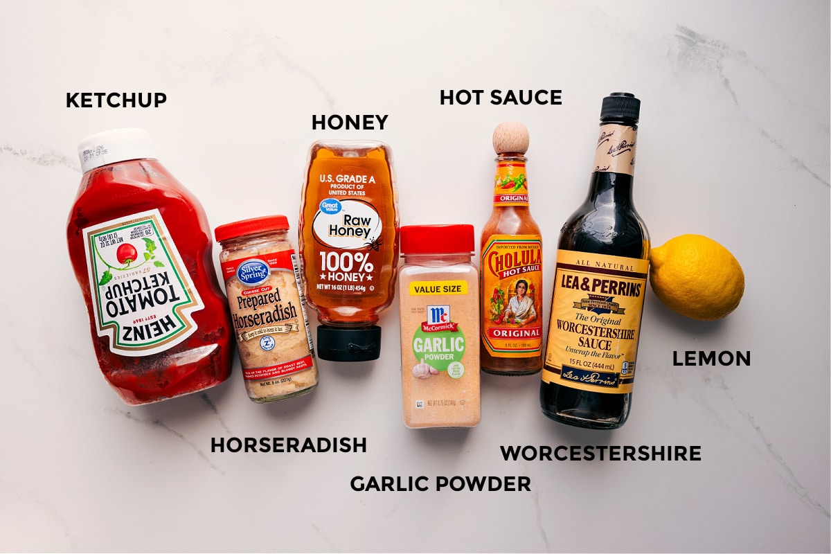 Ingredients In This Cocktail Sauce Recipe All the ingredients in this recipe prepped out for easy assembly including the ketchup, horseradish, honey, garlic powder, hot sauce, Worcestershire, and lemon.